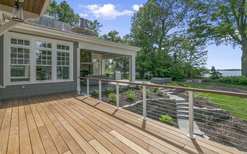 Lakeside luxury home with large wood deck and beautifully landscaped yard